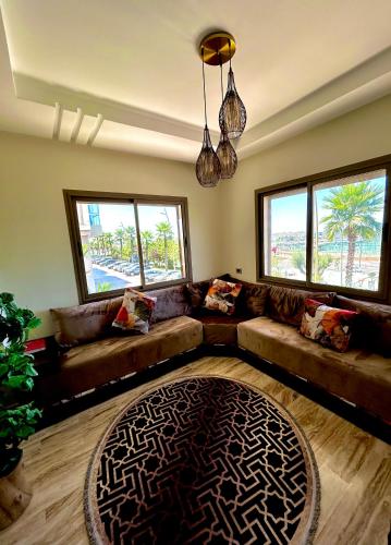 a living room with a leather couch and a rug at Ocean side - Prestige & Douceur familliale in Casablanca