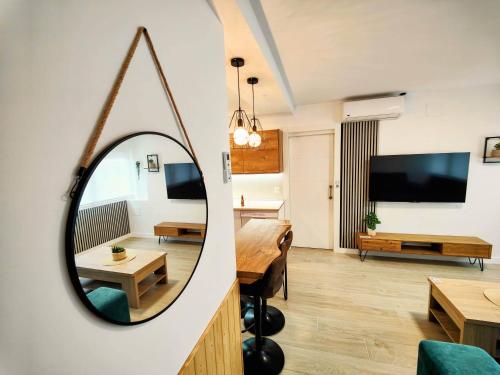 a room with a mirror and a living room at El Andén de Garrido sin ascensor in Salamanca
