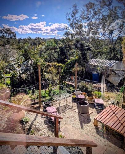 a view of a garden with a table and chairs at Blue Mountains Urban Farm Stay near Sydney in Hazelbrook