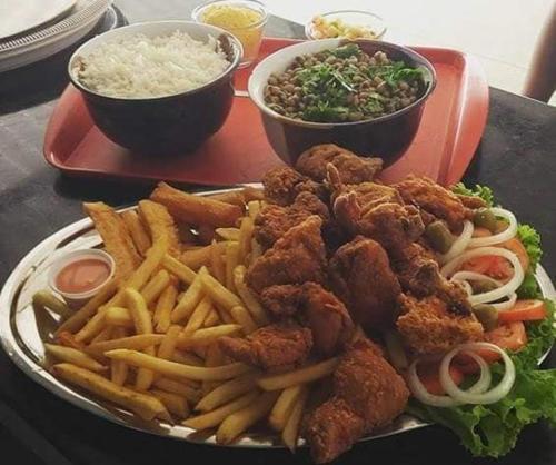 a plate of food with fried chicken and french fries at O Cantinho da Patricia e Tony in Macaíba