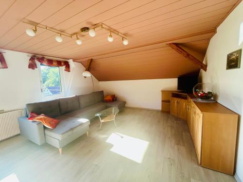 a living room with a couch and a table at Ferienwohnung Schiekel in Sebnitz