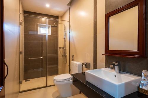 a bathroom with a toilet and a sink and a shower at Casa de LYN Nha Trang in Nha Trang