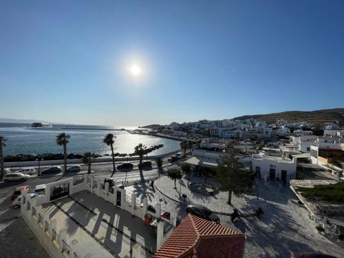 a view of a town with the ocean and buildings at Aegli 1876 in Tinos Town