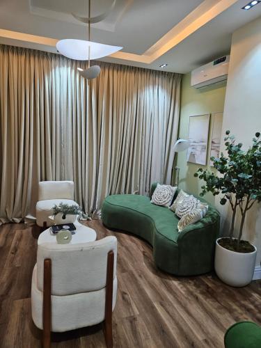 a living room with a green bed and a couch at Eko Luxury Apartments in Ikeja