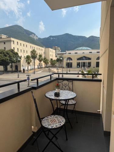 a balcony with a table and chairs and a view of a city at Plaza Rooms Luxury B&B in Pagani