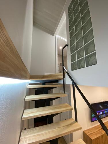 a staircase in a house with wooden steps at Heart of the old town in Kamianets-Podilskyi