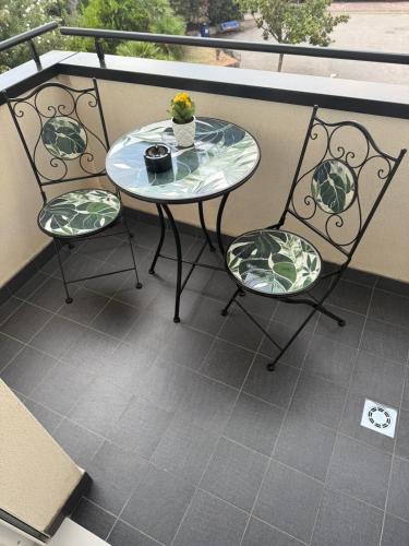 a glass table and two chairs on a balcony at Plaza Rooms Luxury B&B in Pagani