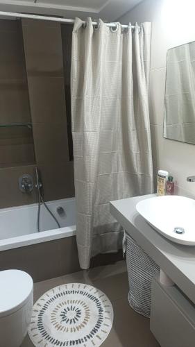 a bathroom with a sink and a toilet and a shower at First Floor Casa Privee - Two bed Beach Terrace & Balconies in Puerto de Sagunto