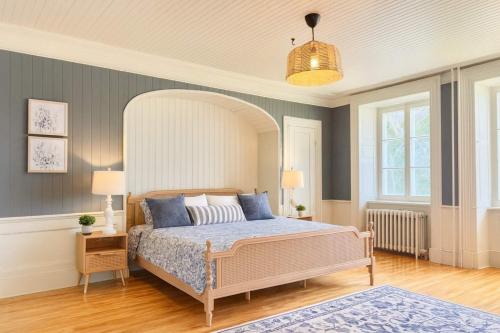 a bedroom with a large bed with blue pillows at The Royal d'Antan 8 people Parking in Quebec City