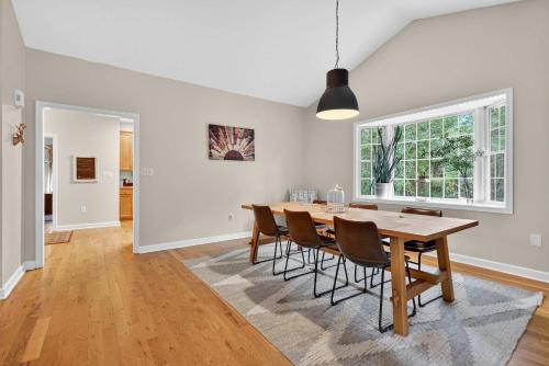 a dining room with a table and chairs at Family Screened Porch with Swing Fire Pit Grill and Deck in Luray