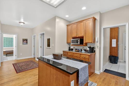 a kitchen with wooden cabinets and a counter top at Family Screened Porch with Swing Fire Pit Grill and Deck in Luray