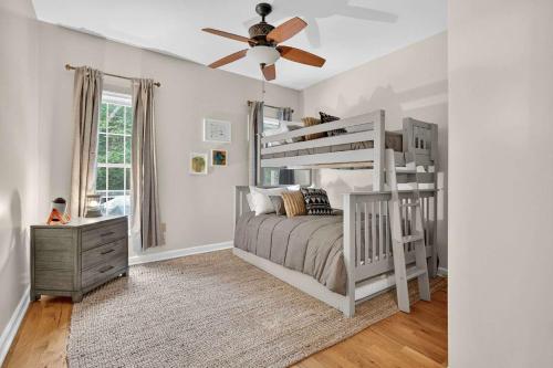 a bedroom with a white bunk bed and a ceiling fan at Family Screened Porch with Swing Fire Pit Grill and Deck in Luray