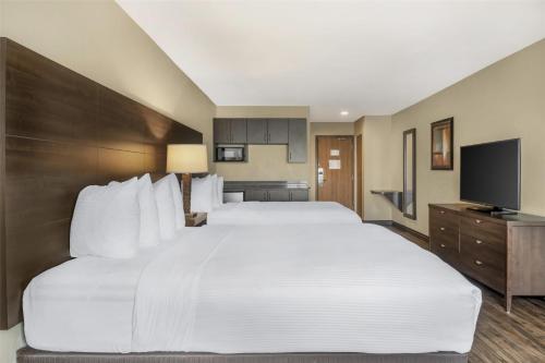 a large white bed in a hotel room at BEST WESTERN PLUS Saint John Hotel & Suites in Saint John