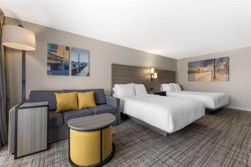 a hotel room with two beds and a couch at Best Western Plus Elgin - Chicago in West Dundee