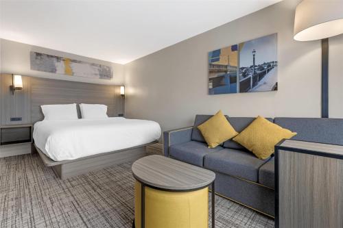 a hotel room with a bed and a couch at Best Western Plus Elgin - Chicago in West Dundee