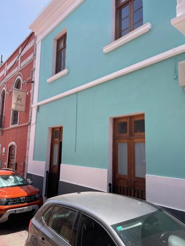 a blue building with a car parked in front of it at Fuerteventura in Ingenio
