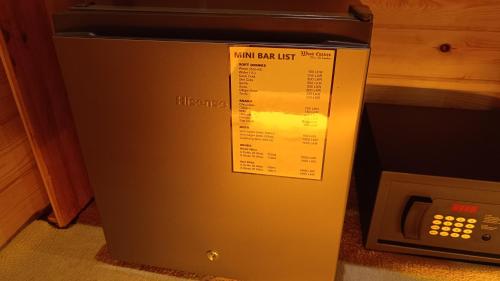a small refrigerator next to a microwave oven at Wood Chalets Ella in Ella