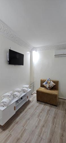 a living room with a bed and a couch at Dar Al Fanouss in Rabat