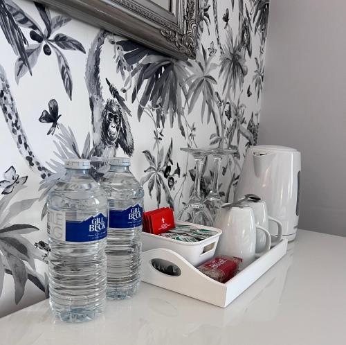 two bottles of water are sitting on a counter at Chadberry House Hotel in Blackpool