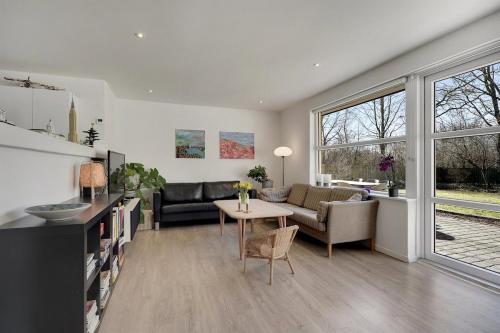 a living room with a couch and a table at A house close to LEGO house in Billund