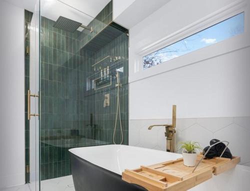 a bathroom with a tub and a glass shower at Aligned Stay in Decatur
