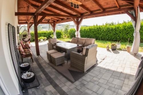 a patio with a table and chairs under a pavilion at Dom w Chomranicach-domek grillowy in Chomranice