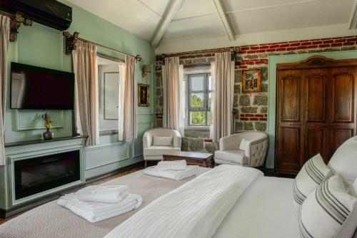 a bedroom with a large bed and a fireplace at Orion Adatepe in Adatepe