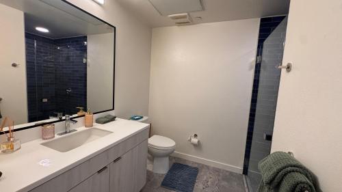 a bathroom with a sink and a toilet and a shower at Luxury Walk of Fame Studio in Los Angeles