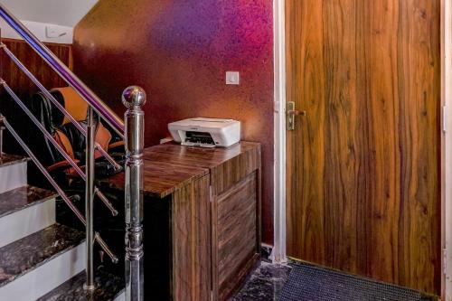 a room with a staircase with a toaster on a wooden desk at Hotel O CeeRock in Bhopal