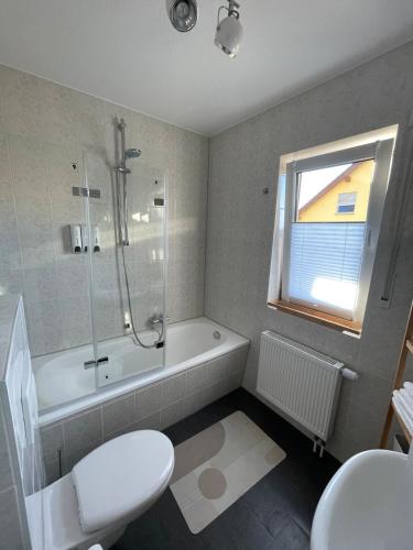 a bathroom with a shower and a toilet and a sink at At home Appartement in Gotha