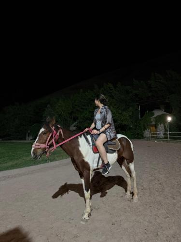 two people riding on a horse at night at MAKSAT Guest House, Horse Riding Kyzart-Song Kol in Dzhangyaryk