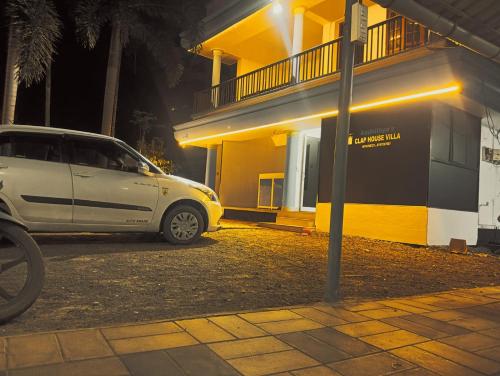 a white van parked in front of a building at Clap House Home in Guruvāyūr