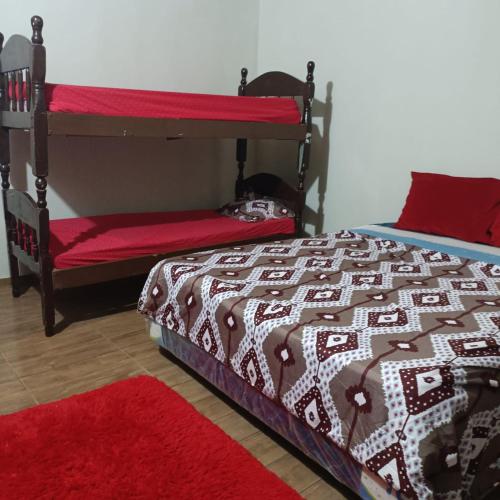 a bedroom with a bed and two bunk beds at Hospedaje Encarnacion in Encarnación