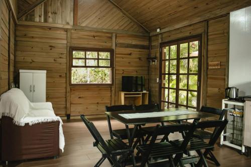 a dining room with a table and chairs at Na Casa da Ilha in Paranaguá