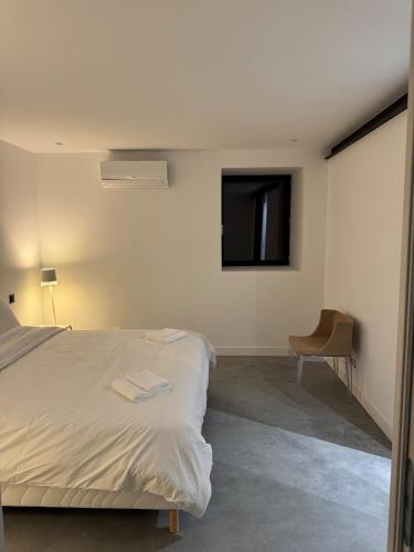 a bedroom with a bed and a tv on the wall at Il Clovio - Discreet luxury, close to Futuroscope in Jaunay-Marigny