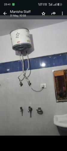 a camera on the wall of a bathroom with a toilet at Hotel vivekanand in Badrīnāth