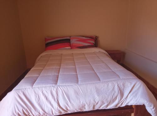 Ένα ή περισσότερα κρεβάτια σε δωμάτιο στο Inti Pacha habitaciones