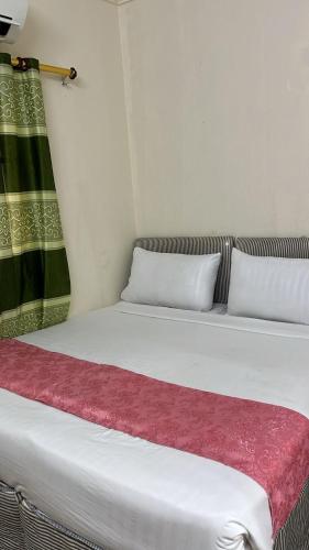 a large white bed with a red blanket on it at Naseem Al Arabi Hotel in Ajyad