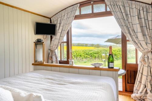 a bedroom with a bed and a window with a view at The Sheep Pen in Bronllys