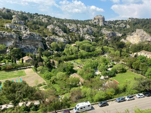 an aerial view of a mountain with cars parked at Les baux in Les Baux-de-Provence