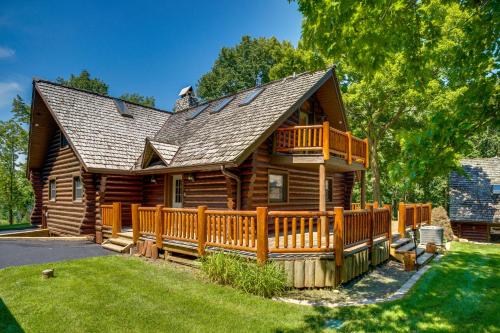 a log cabin with a wooden fence in the yard at Family Home with Indoor Pool about 2 Mi to Elkhart Lake! in Elkhart Lake