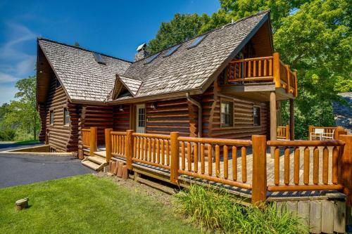 a log cabin with a wooden fence at Family Home with Indoor Pool about 2 Mi to Elkhart Lake! in Elkhart Lake