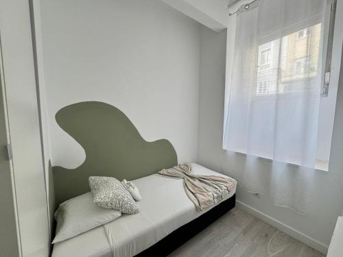 a small bedroom with a bed and a window at Better Choice in Lisbon