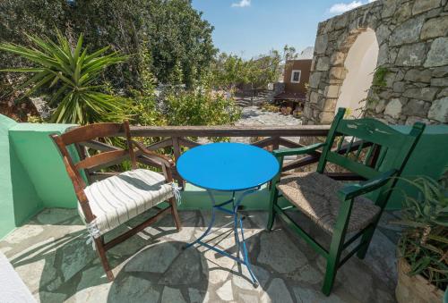 a table and two chairs on a balcony at Arolithos Traditional Village Hotel in Tílisos