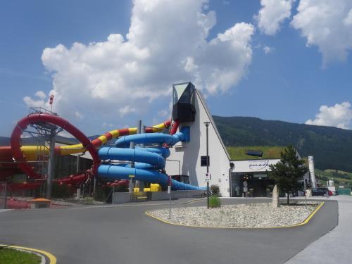 a water park with a water slide in front of a building at Ferienwohnungen Reiter in Flachau