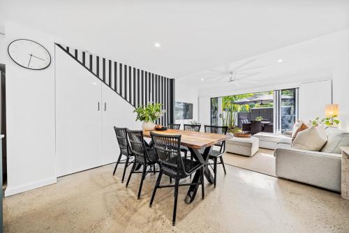 a dining room with a table and chairs at Riverbreeze - Close to Hastings 3 bed AC Pool in Noosa Heads