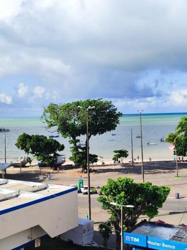 a view of a beach with people in the water at Flat completo 50m da Praia de Tambaú com vista Mar no Terraço e Piscina in João Pessoa