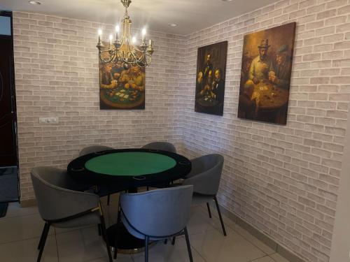 a dining room with a green table and chairs at Royal Flush at Rajgadh Heights 2BHK By THE LOSTINN in Ludhiana