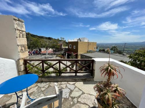 a view of a balcony with a table and chairs at Arolithos Traditional Village Hotel in Tílisos