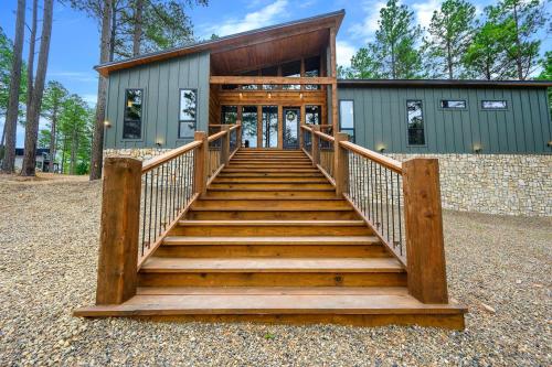a wooden staircase leading up to a house at Jam, Swim, Play - Pool, Hot Tub, Ping Pong, Arcade in Broken Bow